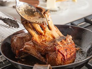 Basting lamb.