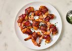 Cooked shrimp on a white plate on a marble surface