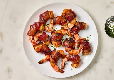 Cooked shrimp on a white plate on a marble surface