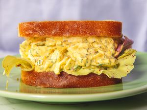 Egg salad sandwich on bread, served on a plate